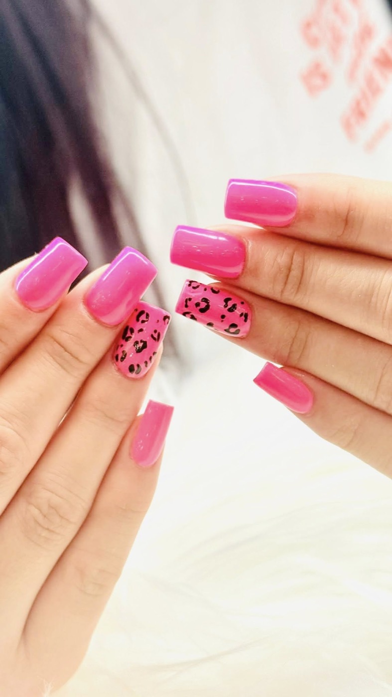 Bright pink nails with leopard accent art